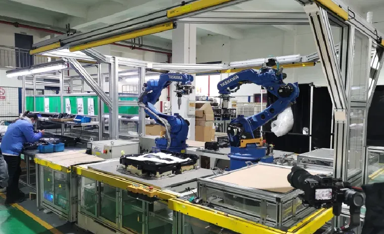 Robotic assembly cell in a Chinese electronics factory with an operator at the line